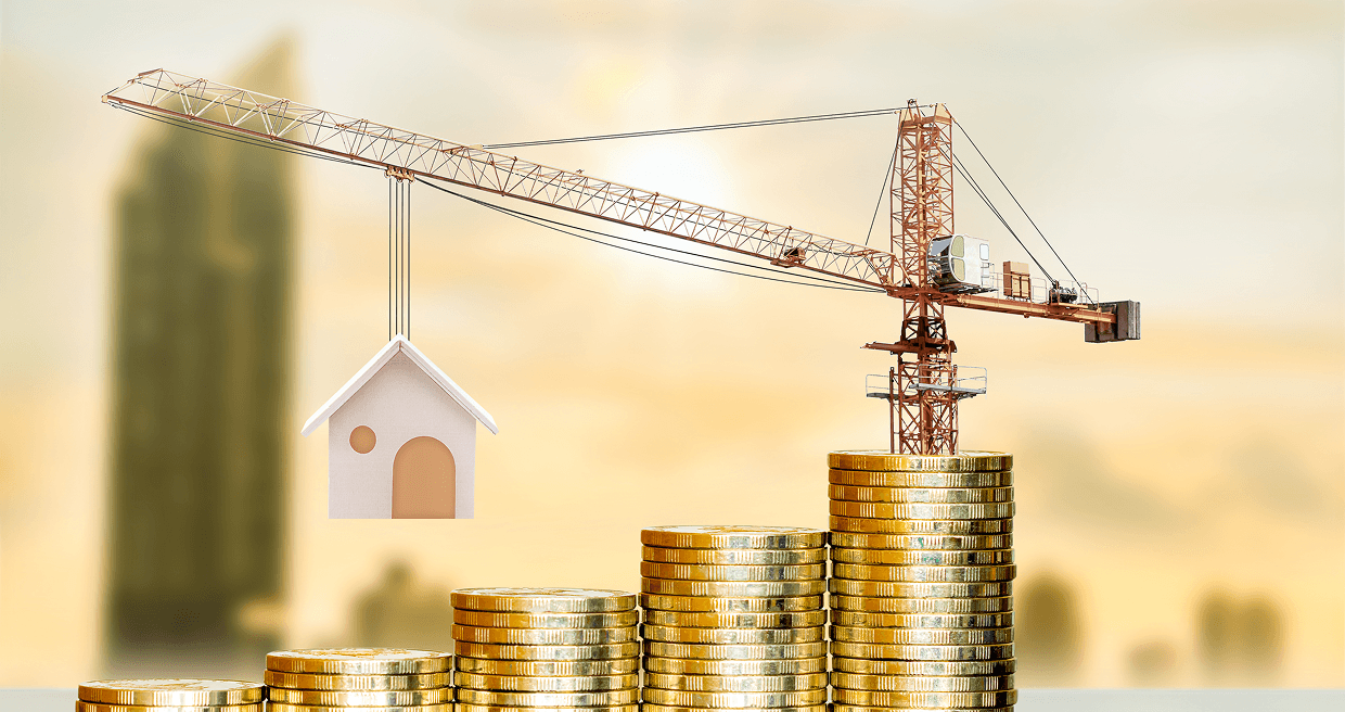 A small boom crane on top of a stack of gold holding a house