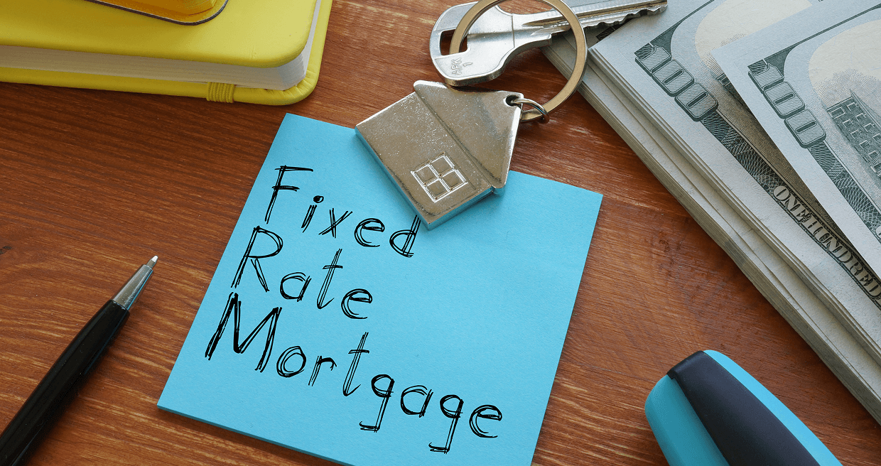 Blue sticky note on a table with "Fixed Mortgage Rates" written on it